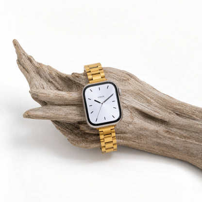 Slim Oyster Apple Watch Band in gold wrapped around a piece of driftwood
