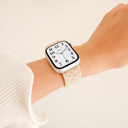 Cloud Nylon Apple Watch Band in spotted starlight worn on wrist with a white knit sleeve, watch face view