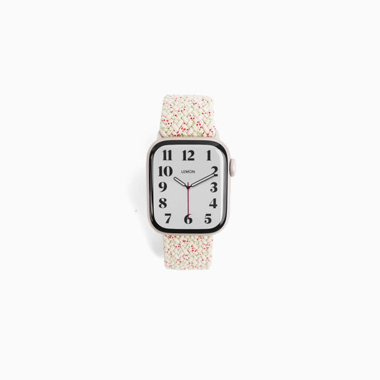 A STARLIGHT nylon Apple Watch band with a pattern of small, scattered multicolored dots.
