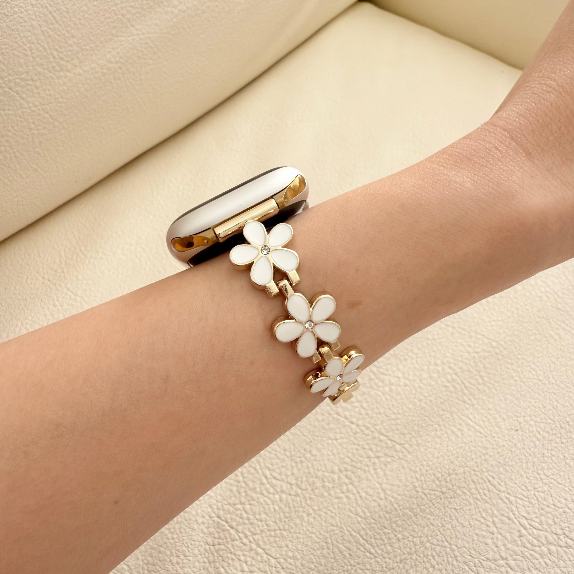 Bracelet with white floral designs on a wrist apple watch series 11