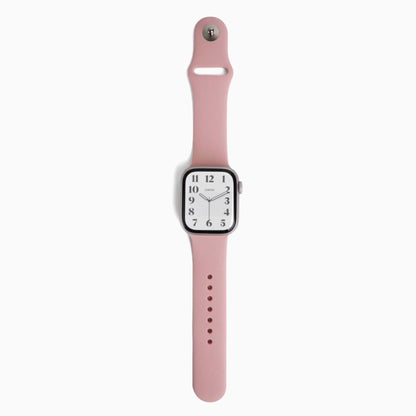 Classic Silicone Apple Watch Band in pink with watch attached, front view on white