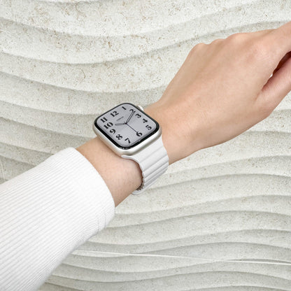 Magnetic Snap Silicone Apple Watch Band in starlight worn on wrist with a white knit sleeve, watch face view
