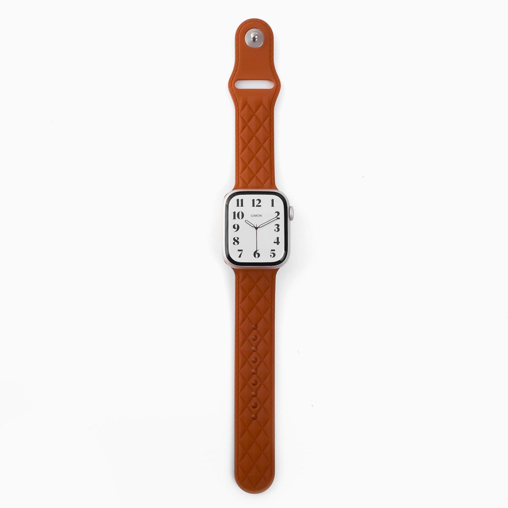 A brown rubber band for an Apple Watch with a lattice-patterned design, displayed against a white background.