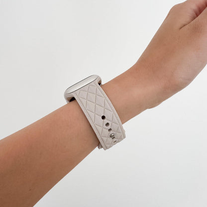 Lattice Silicone Apple Watch Band in Starlight worn on wrist, side view of the quilted pattern