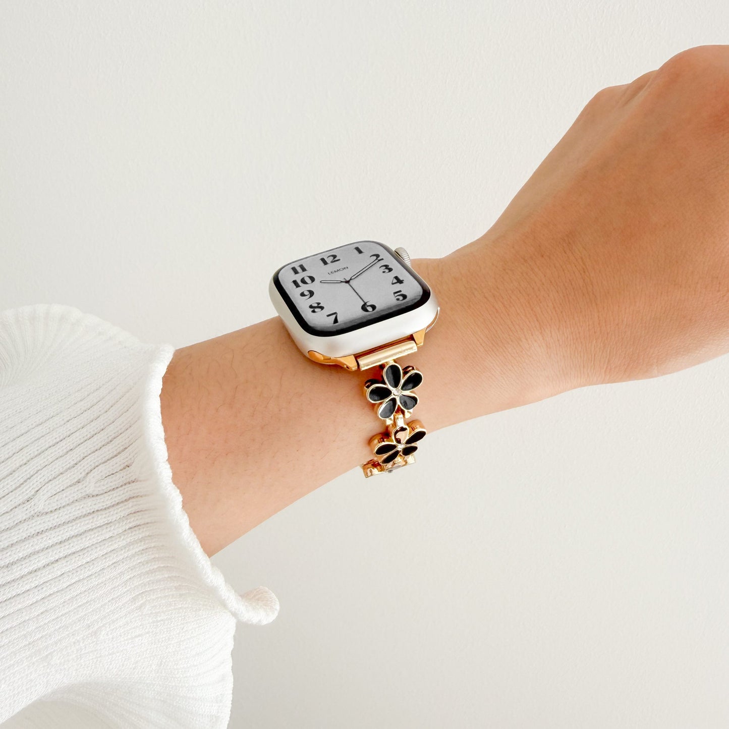 Wrist wearing a gold watch APPLE women