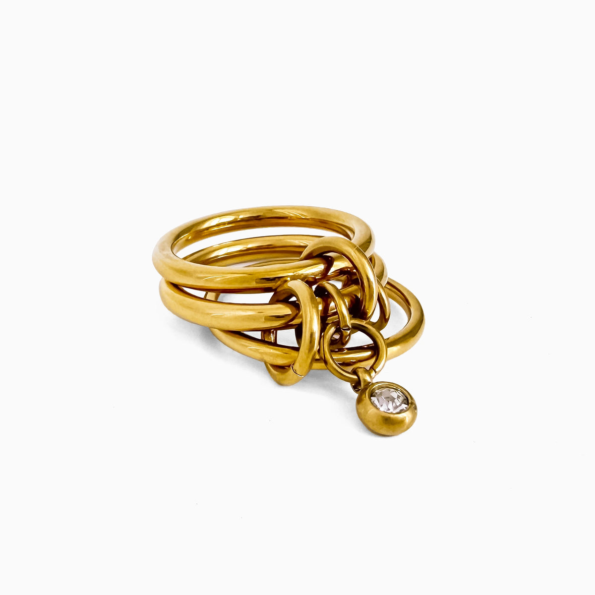 Poppy Charm Ring angled view showing gold-tone bands and the hanging crystal drop charm