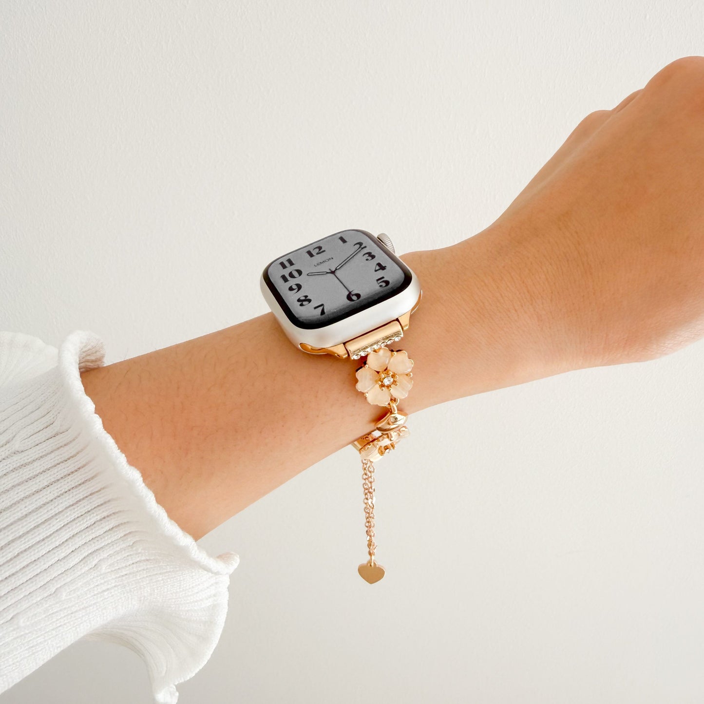 Smartwatch with a decorative floral bracelet on a wrist 