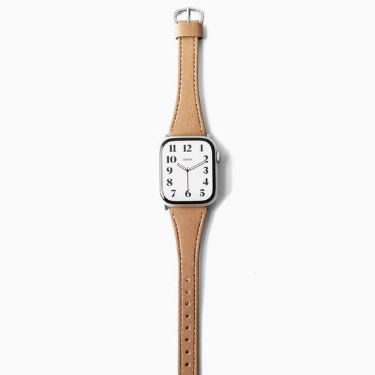 A minimalist analog watch with a square white dial and a light tan leather apple strap, shown vertically against a clean white background.