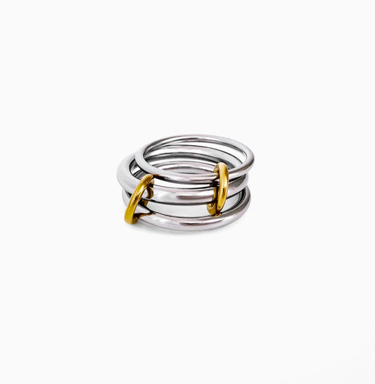 Sloane Linked Ring, three silver-tone bands joined by gold-tone loops, on a white background