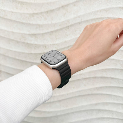 Magnetic Snap Silicone Apple Watch Band in black worn on wrist with a white knit sleeve, watch face view