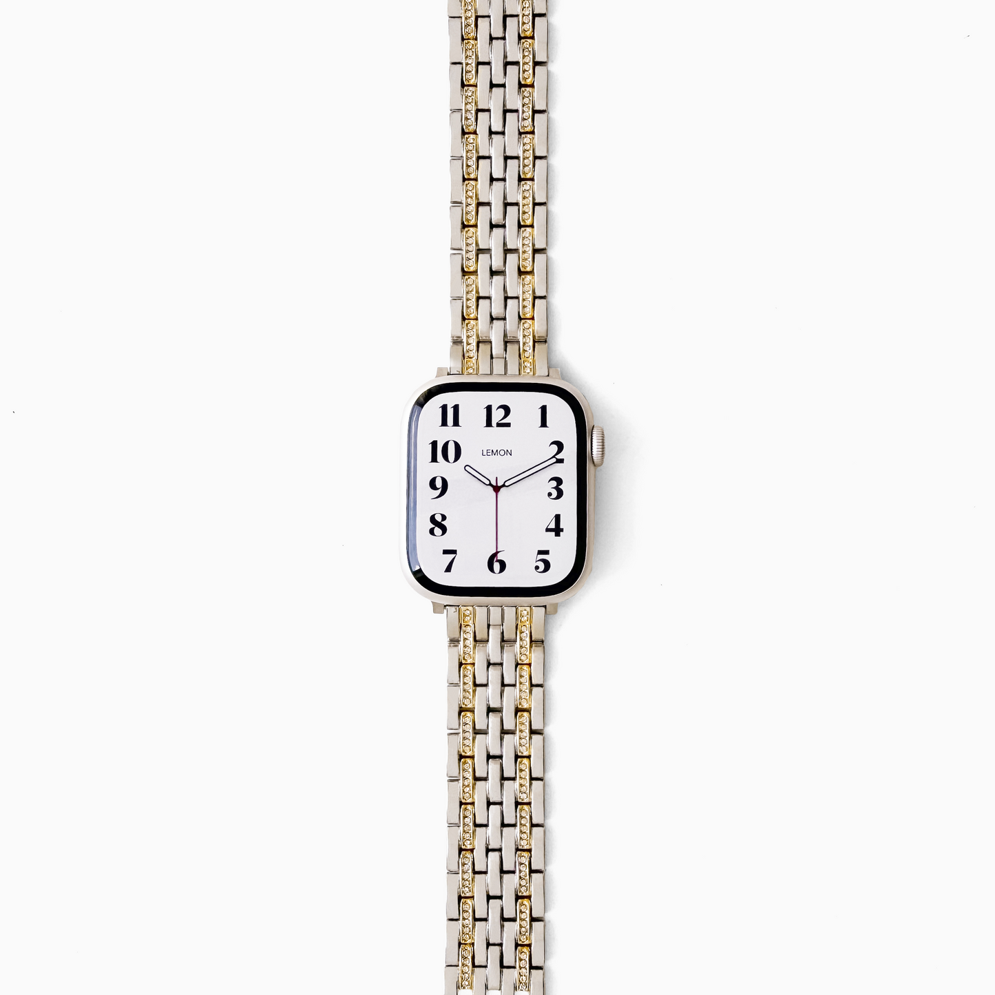 A square-faced analog watch with a white dial and a two-tone metal link band in silver and gold