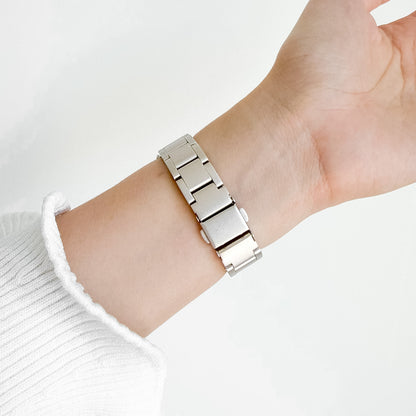 Slim Moon Starlight Apple Watch Band worn on wrist with a white knit sleeve, angled view