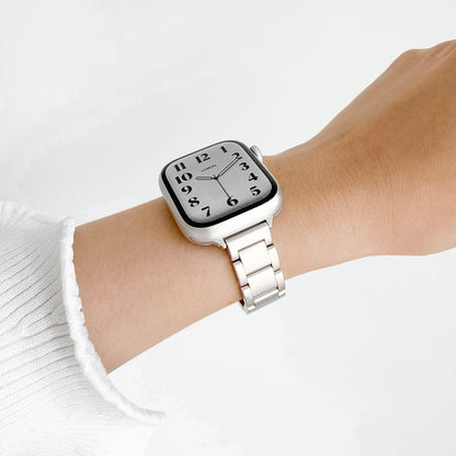 Slim Moon Apple Watch Band in starlight steel worn on wrist with a white knit sleeve, watch face view