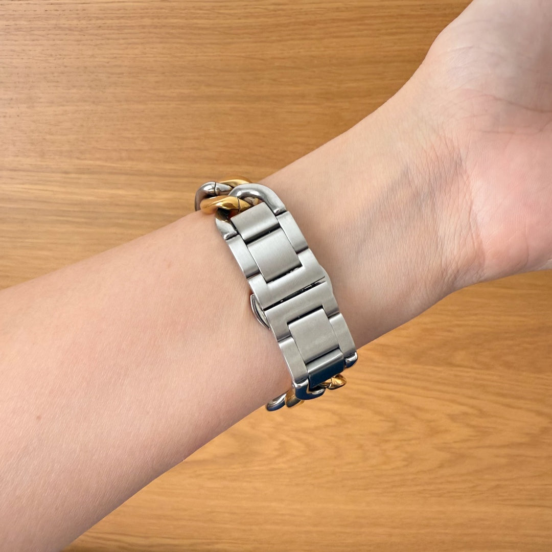 Silver bracelet on a wrist with a wooden background