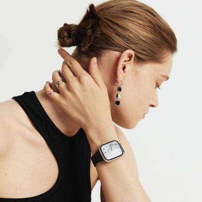Woman wearing the Slim Milanese Apple Watch Band in black, hand resting at her shoulder