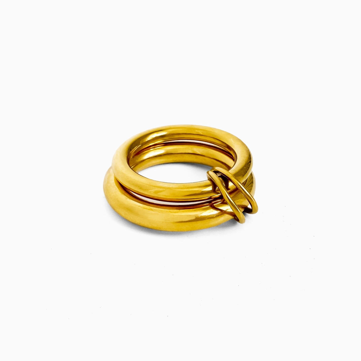 Double Donut Ring, two stacked rounded gold-tone bands joined by small loops, on a white background