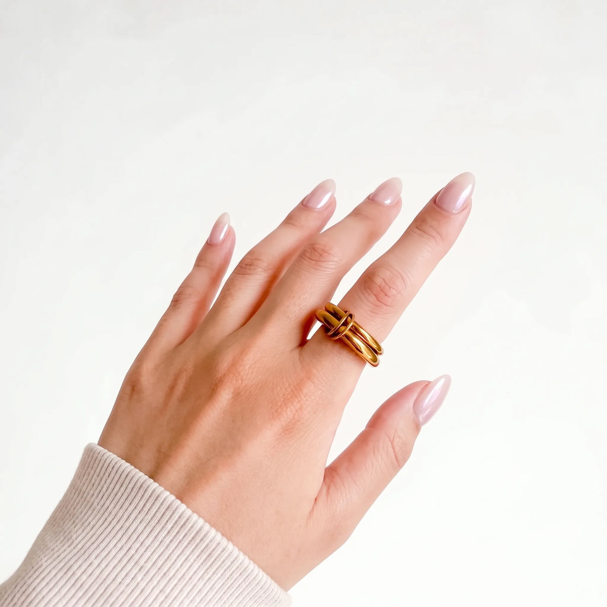 Double Donut Ring worn on a woman's hand, two gold-tone bands on the ring finger