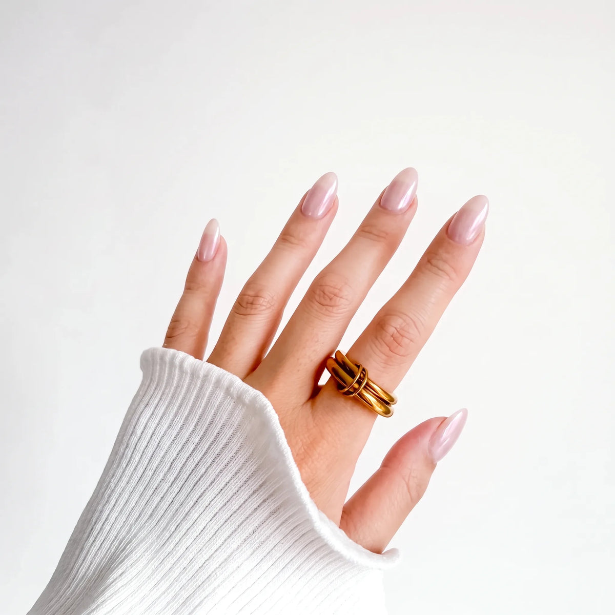 Double Donut Ring on a woman's hand with a white ribbed knit sleeve