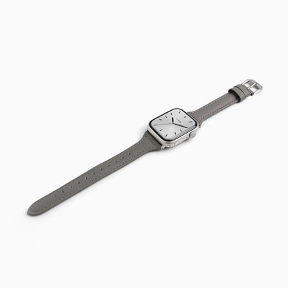 Classic Leather Apple Watch Band in pearl grey, laid at an angle on white