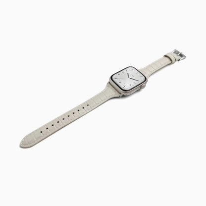 Voyage Leather Apple Watch Band in starlight cream leather, laid at an angle on white