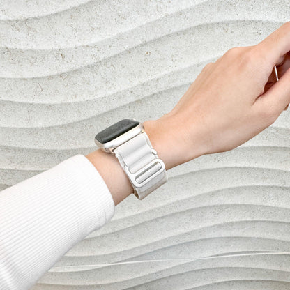 Mountain Nylon Apple Watch Band in starlight worn on wrist with a white knit sleeve, side view