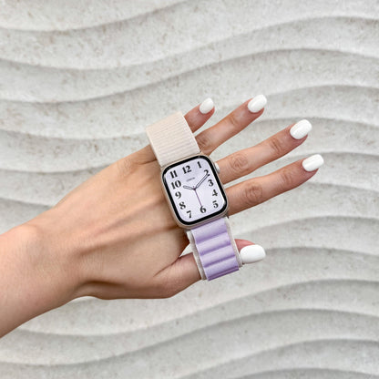 Woman holding up her hand wearing the Mountain Nylon Apple Watch Band in starlight and lavender