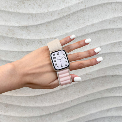 Woman holding up her hand wearing the Mountain Nylon Apple Watch Band in starlight and pink