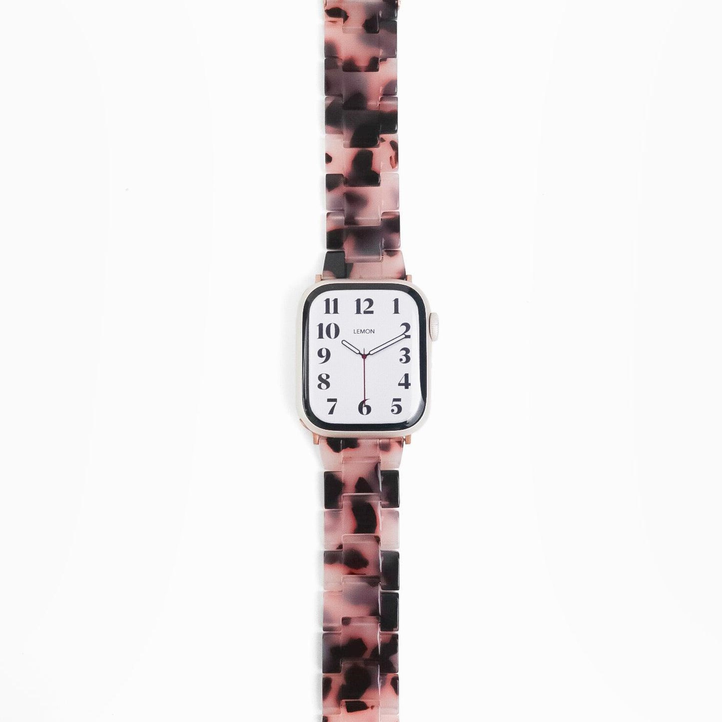 A pink tortoiseshell-patterned resin band for Apple Watch, displayed on a white background.