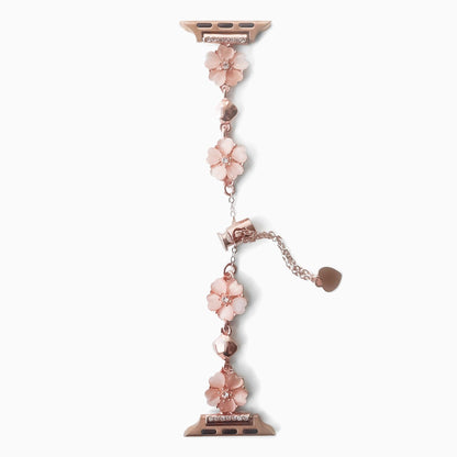 Sakura Chain Apple Watch Bracelet in pink with rose gold flower links and heart charm, flat on white