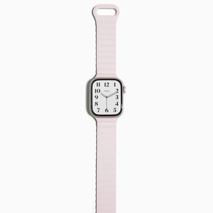 Magnetic Snap Silicone Apple Watch Band in light pink with watch attached, front view on white