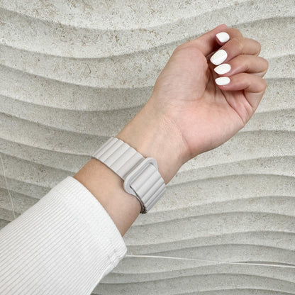 Magnetic Snap Silicone Apple Watch Band in starlight worn on wrist, side view with white nails