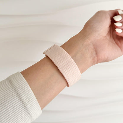 Soft Nylon Apple Watch Loop in light pink worn on wrist, close view of the woven nylon strap