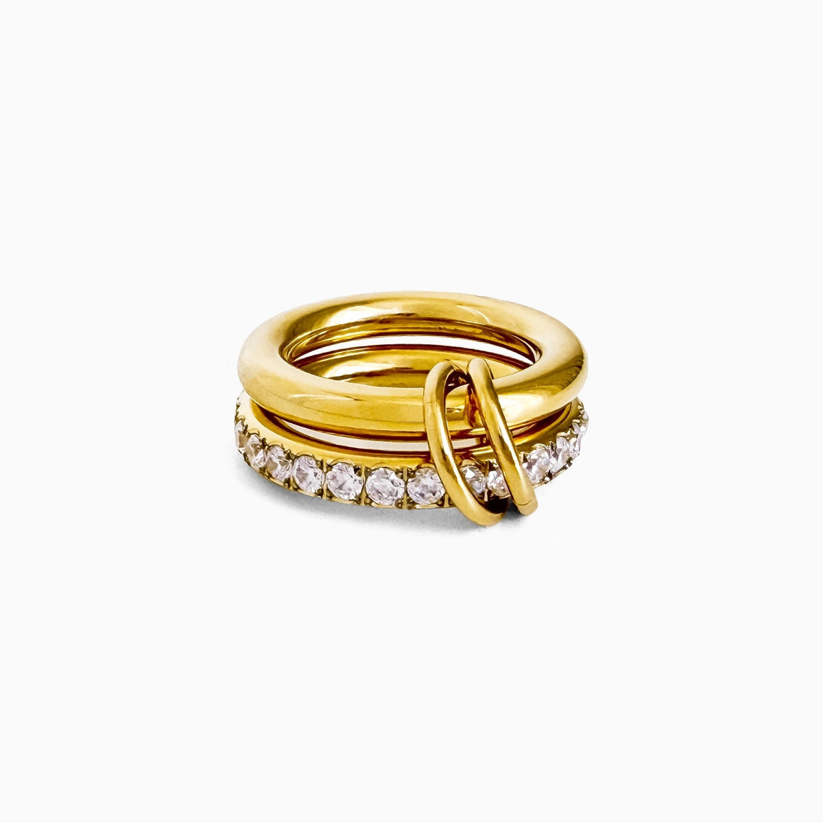 Sprinkled Donut Ring in gold, smooth gold-tone band stacked with a clear crystal band, on a white background