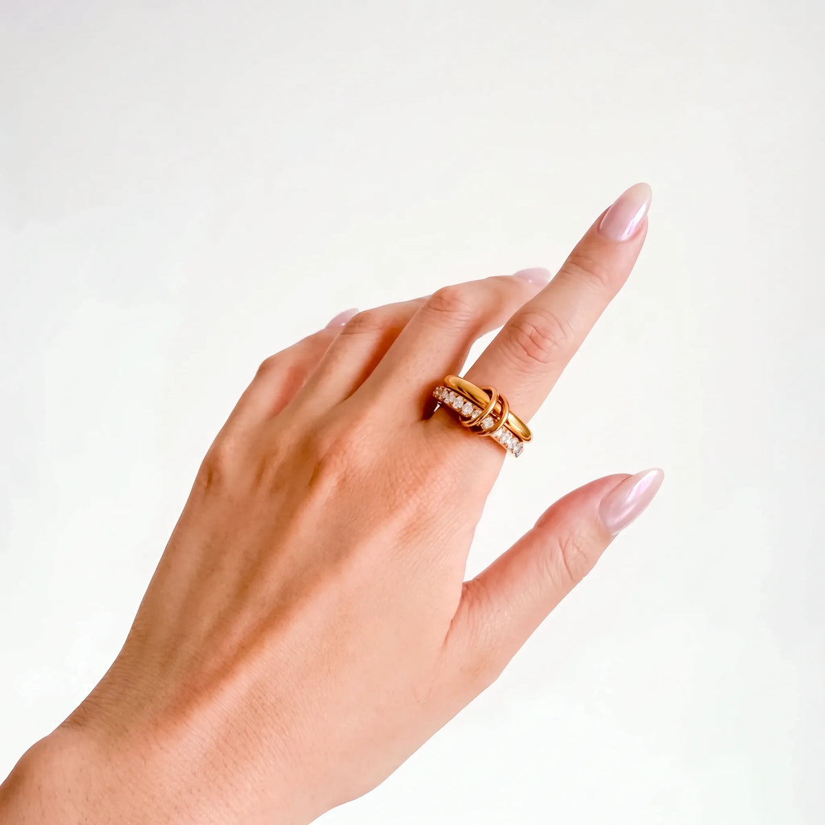 Sprinkled Donut Ring in gold on a woman's hand, crystal band and gold band, side angle