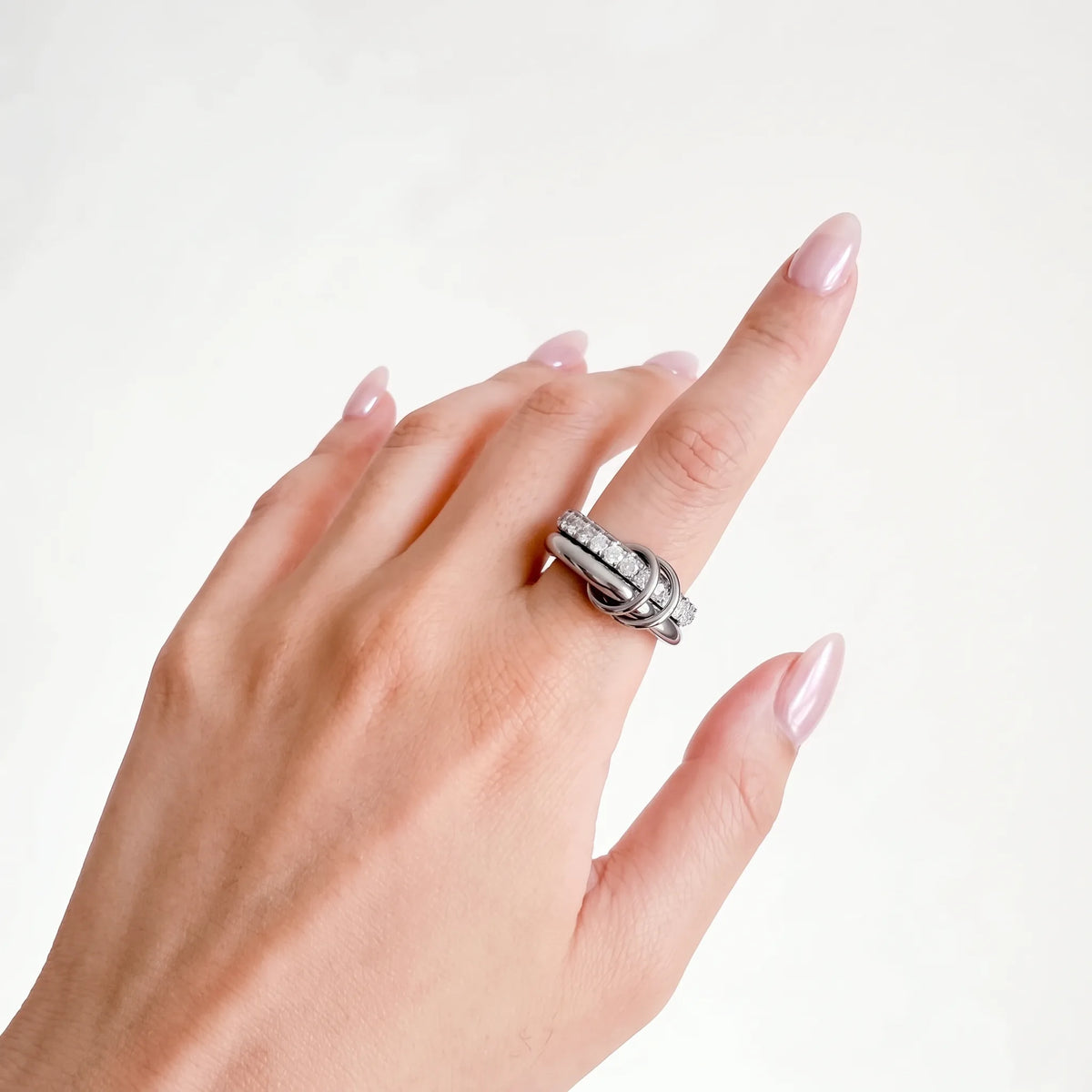 Sprinkled Donut Ring in silver on a woman's hand, crystal band and silver band, side angle