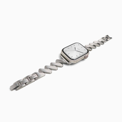 Lightning Apple Watch Band in silver zigzag links, laid at an angle on white
