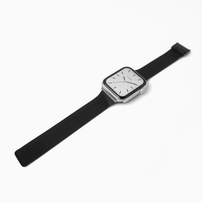 Slim Milanese Apple Watch Band in black stainless steel mesh, laid at an angle on white
