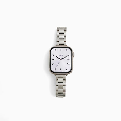 Slim Oyster Apple Watch Band in silver stainless steel, watch face view on white
