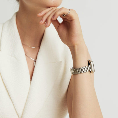 Woman wearing the Slim Oyster Apple Watch Band in silver, hand resting at her chin