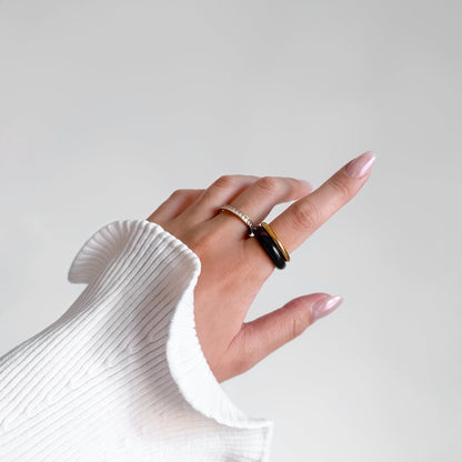 Tiramisu Ring Set split across two fingers, rhinestone row band on one and jasper band with gold ring on the other