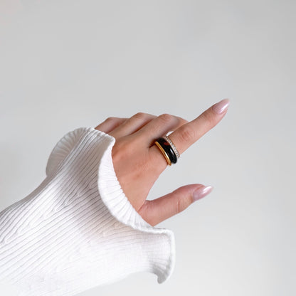 Tiramisu Ring Set stacked on one finger, gold rhinestone row band, jasper band and smooth gold ring, white ribbed knit sleeve